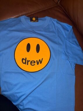 drew house Light Blue Tee with Orange Smiley Graphic
